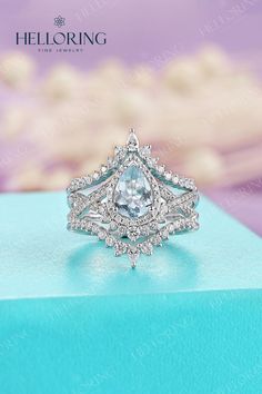 a diamond ring on top of a blue box