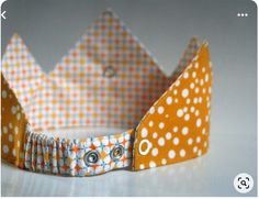 an orange and white crown with polka dots on it