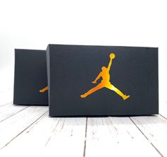 two black boxes with gold jordan logos on them