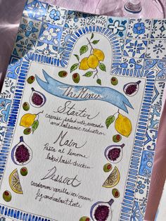 a blue and white menu with fruit on it