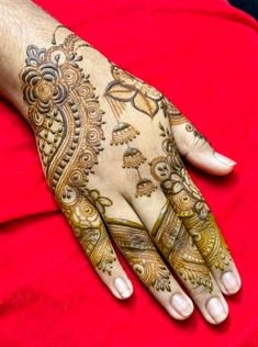 the hand is decorated with henna designs