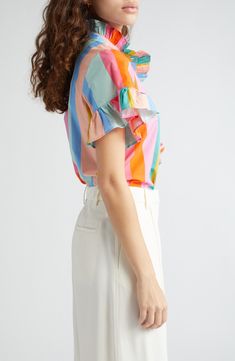 A crisp cotton blouse goes in for the charm with ripples of ruffles embellishing the placket and sleeves. 26" length (size Medium) 100% cotton Dry clean Imported Multicolor Cotton Ruffle Sleeve Tops, Multicolor Cotton Top With Ruffle Sleeves, Multicolor Cotton Tops With Ruffle Sleeves, Multicolor Cotton Flutter Sleeve Top, Multicolor Cotton Ruffle Tops, Multicolor Cotton Tops With Flutter Sleeve, Cotton Ruffle Sleeve Blouse With Ruffles, Multicolor Flutter Sleeve Blouse With Ruffles, Cotton Blouse With Flutter Sleeve For Work