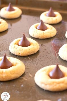 some cookies with chocolate on them sitting on a pan