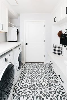 a black and white tiled floor in a laundry room