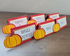 three pumpkin themed place cards on a table