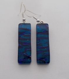 I fused 3 layers of glass to create this gorgeous earring ,black opaque glass as base ,dichroic glass in the middle and clear glass on the top. The size is 1 1/4 " by 3/8" .All my jewelry come in a nice gift box. Iridescent Glass Earrings For Gift, Dichroic Glass Jewelry, Dangly Earrings, Dichroic Glass, Glass Earrings, Earrings Photo, 3 Layers, Gorgeous Earrings, Glass Jewelry