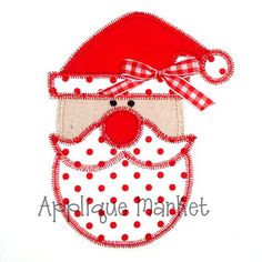 a red and white santa claus face with polka dots