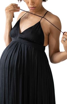 Keep your look effortlessly luxe any day in a billowy sundress crafted with a bump-flattering silhouette featuring a hidden panel for easy and discreet nursing. The lightweight fabric is made from post-consumer plastic bottles, so you'll not only look your best but feel your best too. V-neck Adjustable tie straps Side pockets 100% recycled polyester Dry clean Imported Women's Clothing This product meets the Global Recycled Standard (GRS), a voluntary certification for products with at least 20% Elegant Sleeveless Bump Friendly Dresses, Elegant Sleeveless Bump-friendly Dresses, Chic Nursing Friendly Maternity Dress, Chic Maternity Dress Nursing Friendly, Black Sleeveless Summer Maternity Dress, Chic Maxi Maternity Dress, Summer Sleeveless Bump Friendly Dresses, Summer Sleeveless Bump-friendly Dresses, Elegant Summer Maternity Midi Dress