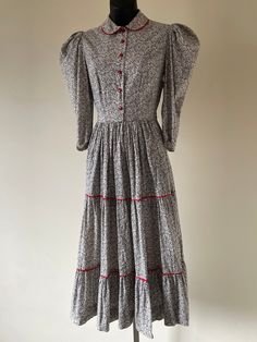 "Antique 1930s Black & White Floral Prairie Dress. Peter Pan collar. Puffed 3/4 length sleeves. Cherry red buttons & ric-rac trim. Original metal 'Conmar' zipper at side of garment. Measurements: Bust: 34\" Waist: 28\" Hips: Open Length: 46\" Condition: Excellent, vintage condition." Fitted Long Sleeve Prairie Dress With Buttons, Velvet Circle Skirt, Dress Peter Pan Collar, 1910s Fashion, Printed Cotton Dress, Ric Rac, Dreamy Dress, Black Velvet Dress, Prairie Dress