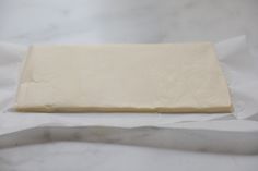 a piece of dough sitting on top of white paper