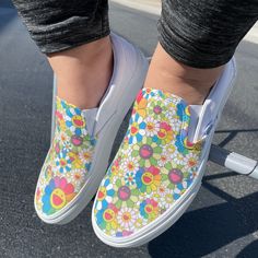 These White Slip On Vans have a fun and colorful design inspired by Takashi Murakami's Rainbow Flower artwork. We buy each pair of shoes BRAND NEW. Each pair is made to order, please make sure you put in the correct shoe size before you check out. The ink is permanent and will never come off, fade away, or peel off. Made in the USA. This price includes everything: shoes and artwork. Because the artwork is custom made for you, there are no exchanges or returns. Please know your size before orderi Multicolor Floral Print Slip-on Sneakers, Retro Style Custom Multicolor Sneakers With Rubber Sole, Fun Spring Sneakers With Rubber Sole, Multicolor Custom Sneakers For Spring, Multicolor Custom Sneakers With Round Toe For Spring, Fun Multicolor Slip-on Sneakers, Retro White Canvas Shoes For Spring, Multicolor Slip-on Sneakers With Floral Print, Casual Hand Painted Slip-on Custom Sneakers