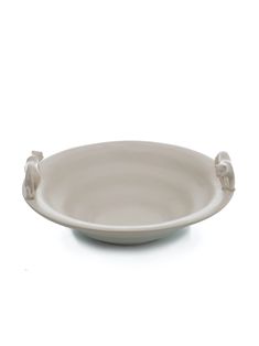 a white plate with two small animals on the rim and an oval bowl in the middle