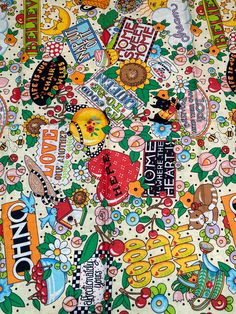 an assortment of stickers and decals on a table cloth covered in white fabric