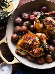 chicken and potatoes in a pan on a table