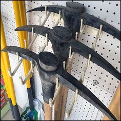 there are many different types of knives hanging on the pegs in this store display