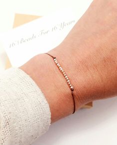 a woman's arm with a bracelet on it