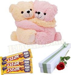 two teddy bears sitting next to each other with a candy bar in front of them