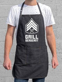 a man wearing an apron that says grill sergeant