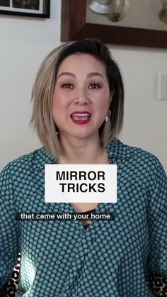 a woman holding up a sign that reads mirror tricks that came with your home on it