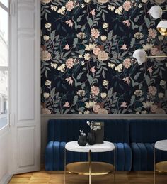 an elegant living room with floral wallpaper and blue velvet couches in front of a large window