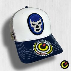 Complete your Outfit with our Blue Demon Mexican Wrestling Legend Premium Cap and take your Mexa pride everywhere Blue Trucker Hat With Embroidered Patch, Blue Snapback Trucker Hat With Embroidered Patch, Blue Embroidered Snapback Trucker Hat, Blue Curved Bill Trucker Hat For Sports Events, Blue Trucker Hat For Fan Merchandise, Adjustable Blue Trucker Hat For Fans, Embroidered Mask, Mexican Wrestling, Blue Demon