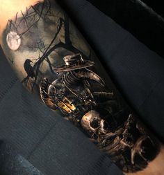 a man's arm with a tattoo on it that has a skeleton riding a motorcycle