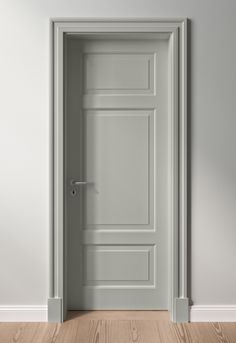 an open door in a white room with wood flooring and gray walls is shown