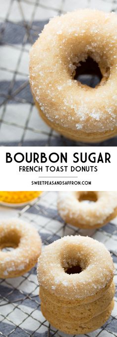 four sugar donuts sitting on top of a cooling rack next to an orange slice