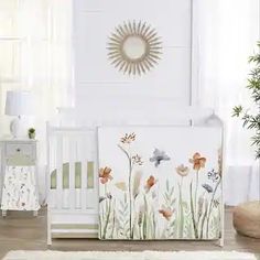 a white crib with flowers and birds painted on it