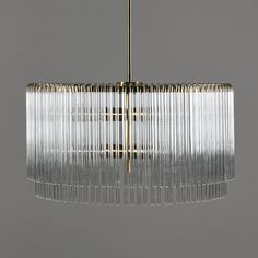 a chandelier hanging from the ceiling with glass strips on it's sides