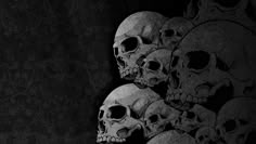 a bunch of skulls are lined up against a black background