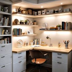 a home office with shelves, desk and chair in the corner between two shelving units