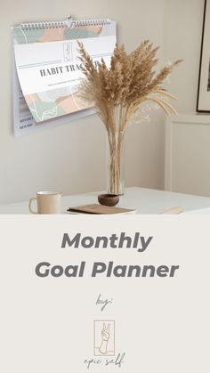 a white desk with a plant and cup on it