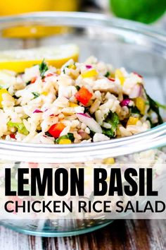 lemon basil chicken rice salad in a glass bowl on a wooden table with lime wedges