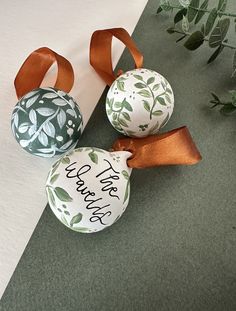 three decorated eggs with ribbons on them