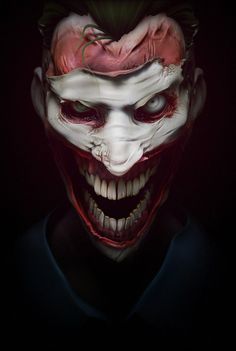 a creepy clown with red hair and white teeth is shown in the dark, looking at the camera