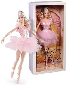 a barbie doll in a pink tutu and tiara is posed next to a box