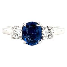 a blue sapphire and diamond three stone ring