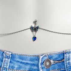 Product DetailsBlue Gem Heart Colorful Butterfly Belly Ring Belly Chain Don't let your midriff go bare when you wear your favorite halter top or belly shirt. This sexy belly chain jewelry is attached to a 14 gauge navel ring made with a 3/8 inch 316L surgical grade stainless steel curved barbell with a 5mm top ball end. The bottom end features a butterfly charm, embellished with multi-color inlay. The bottom of the butterfly's wings have a chain dangling from them, which supports a blue heart-sh Belly Button Piercing Waist Chain, Naval Piercing, Belly Shirt, Conch Piercing Jewelry, Opal Nose Ring, Daith Piercing Jewelry, Pregnancy Belly Rings, Horseshoe Jewelry, Belly Piercing Jewelry