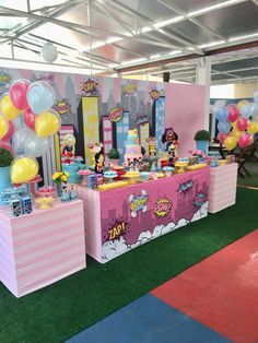 a table set up with balloons, cake and decorations for a kids's birthday party