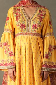 Yellow anarkali with all-over floral prints, embroidered yoke and sleeves. Comes with contrast floral embroidered dupatta and striped pant. - Aza Fashions Bohemian Maxi Salwar Kameez For Navratri, Bohemian Maxi Length Salwar Kameez For Navratri, Bohemian Maxi-length Salwar Kameez For Navratri, Bohemian Maxi Length Salwar Kameez For Festivals, Festive Anarkali Palazzo Set With Embroidered Border, Anarkali Palazzo Set With Embroidered Border For Diwali, Festive Floor-length Anarkali Set With Embroidered Border, Bohemian Kurta With Gota Work For Navratri, Bohemian Gota Work Kurta For Navratri