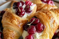 croissants with cherries and whipped cream on them