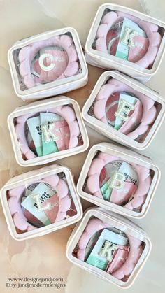 six small containers filled with pink items on top of a table