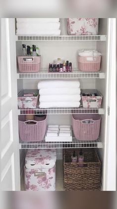 an organized closet with white shelves and pink baskets on the bottom shelf, filled with personal care items