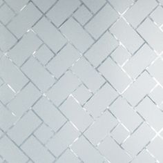 a white tiled wall with small squares on it