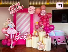 a birthday party with balloons and decorations on the table in front of a pink car