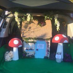 the back of a car decorated with flowers and mushrooms