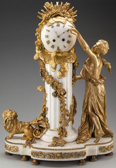 an ornate clock with statues around it