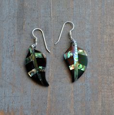 These beautiful earrings feature a cute carved Abalone shell Leaf set with black resin. . The iridescence of the Abalone shell is really amazing. Depending on the light source they will radiate colors varying from greens and pinks to purples and blues. The shells are then polished to a high gloss to reveal the beauty of their natural pattern. The perfect way to complete your beach outfit and everyday wear. DETAILS - Shell types : Abalone, Paua Shell - Material: Sterling Silver Ear Wire and Jump Black Inlay Jewelry As A Gift, Black Jewelry With Inlay For Gift, Gift Shell-shaped Mother Of Pearl Earrings, Shell-shaped Mother Of Pearl Earrings For Gift, Abalone Shell Earrings For Pierced Ears As A Gift, Gift Abalone Shell Earrings, Unique Shell-shaped Earrings For Gift, Gift Abalone Shell Earrings For Pierced Ears, Multicolor Shell-shaped Jewelry Gift