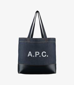 - Tote bag in Japanese canvas.- Two large handles to carry the bag by hand or on the shoulder.- Large panel in smooth leather at bottom of bag.- Reinforced base.- Interior zip pocket.- Large A.P.C. logo in front.- Caramel topstitching on the denim. Apc Bag, C Logo, Faux Leather Bag, Japanese Denim, Backpack Tote Bag, Dark Navy Blue, Tote Backpack, A P, Canvas Bag